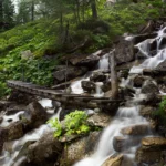 Thumbnail of Long exposure photograph of a bridge with water and clouds smoothed, achieved with a variable ND filter