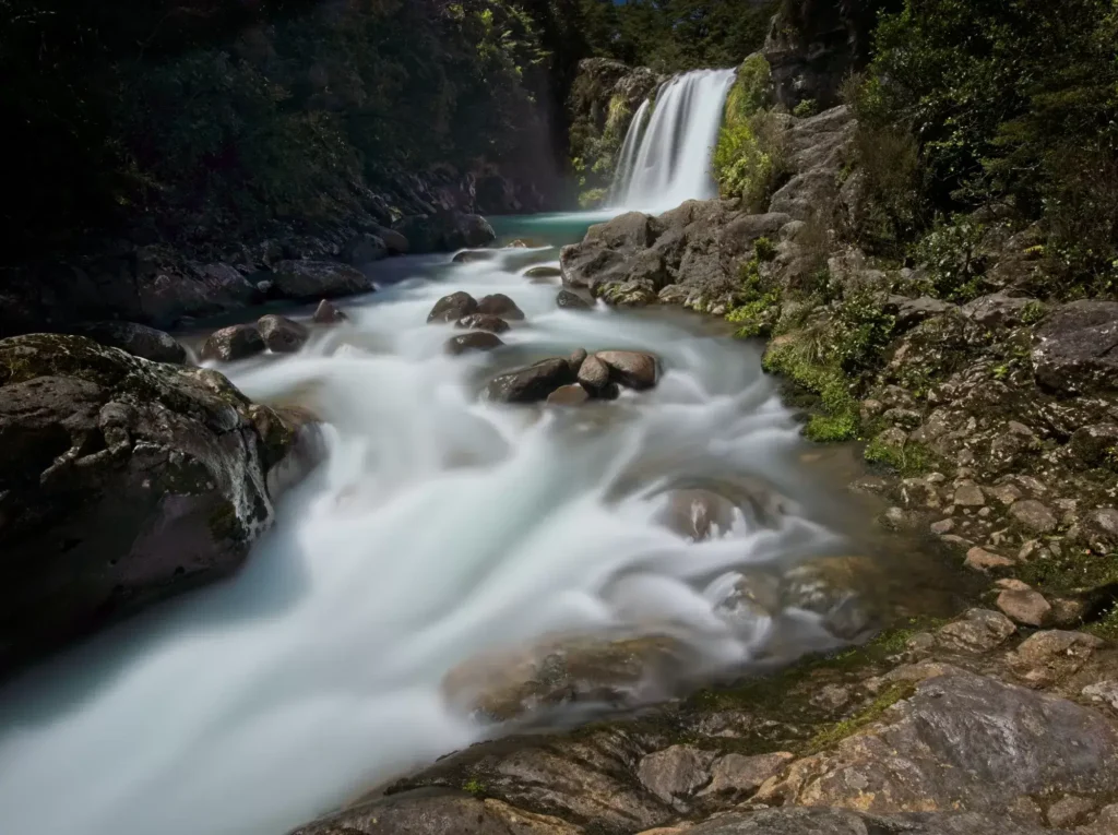 Long exposure of Tawhai Falls, using a mist diffusion filter to turn the rushing cascade into silky smooth streams
